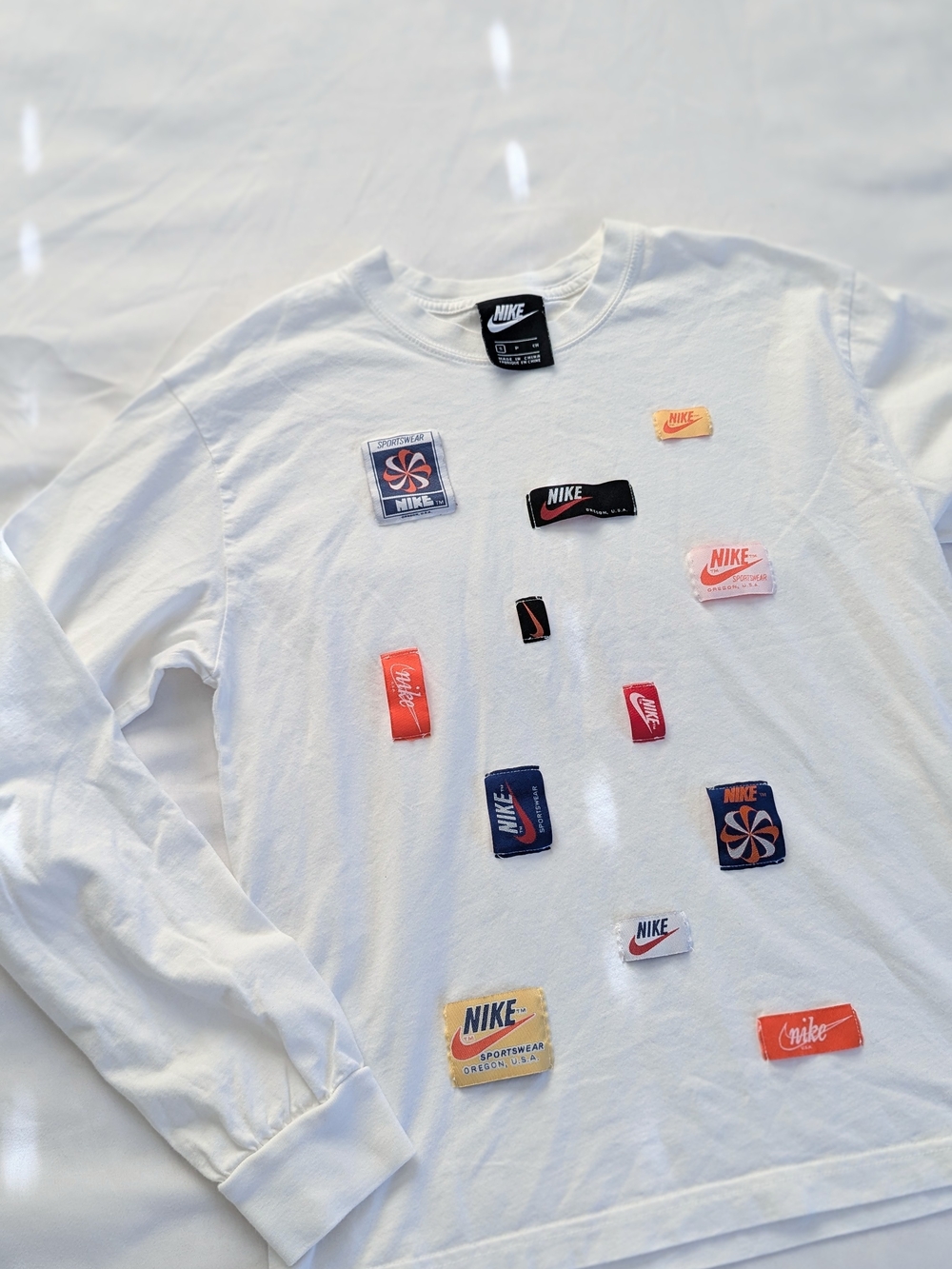 Nike White Long Sleeve Tee with Black and Red Logo Patches